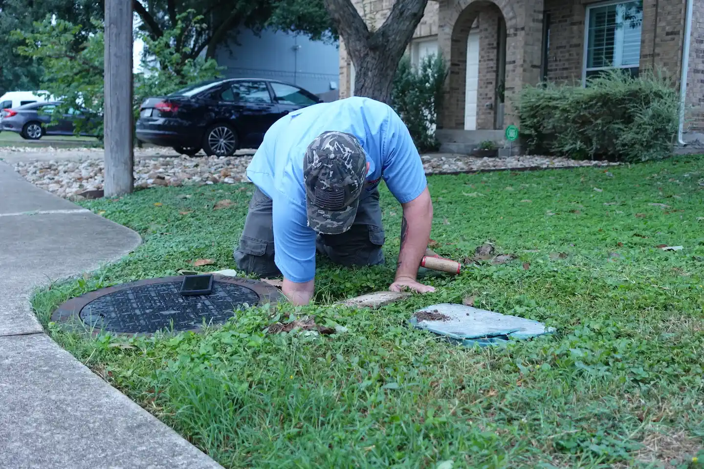 A plumber locating a leak in the front yard of a home in Austin, Texas.