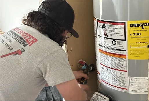 Home 3 A plumber performing work on a water heater in a Texas home.